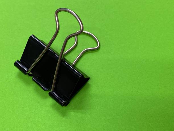 istock Black paperclip with black background 1497086971