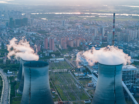 Thermal power plant and cooling towers at sunset