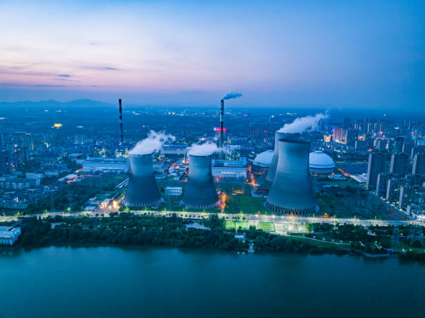 istock Thermal power plant night view, cooling tower 1497088705