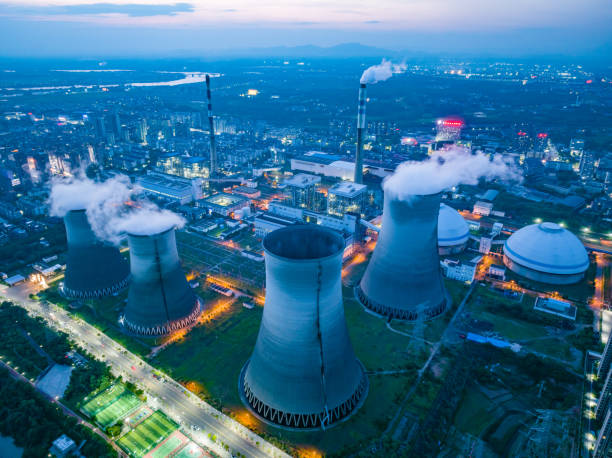 istock Thermal power plant night view, cooling tower 1497088755