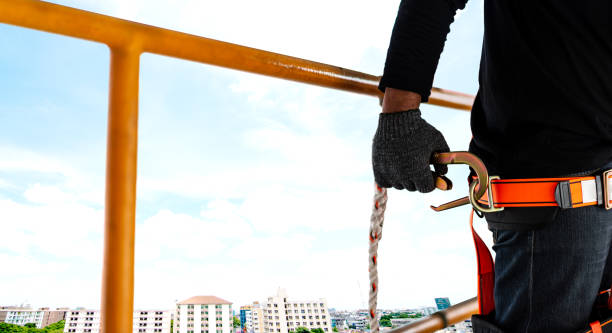 istock Construction worker wearing safety harness working at high place 1497091198