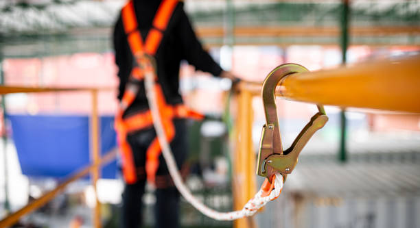construction worker wearing safety harness working at high place - säkerhetssele bildbanksfoton och bilder