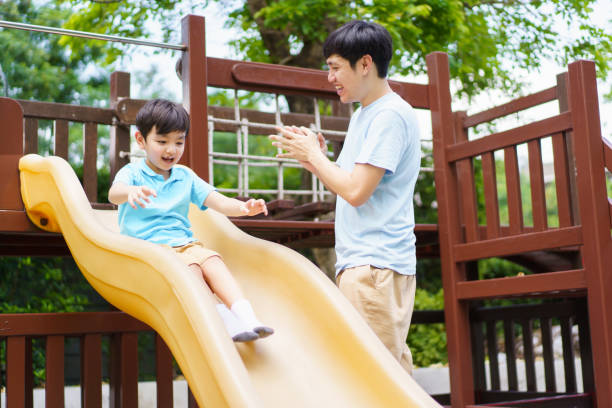 istock Boy and dad playing in playground. 1497091632