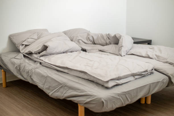 istock Empty bed in a white room. Hotel room, double bedroom. 1497091949