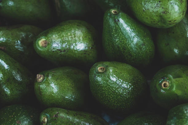 istock Fresh organic avocados, top view 1497092145