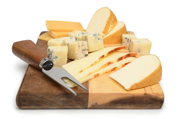 istock Variety of cheeses with cheese fork on a wooden board 1497092798