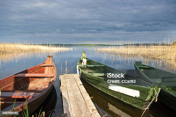 Scene With Two Boats Lake And Pier Stock Photo - Download Image Now - Beauty, Beauty In Nature, Blue