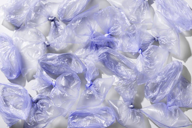 istock Plastic Bag Free Day background. Violet monochrome plastic bags top view pattern, texture polyethylene packages. Zero waste Eco friendly shopping. Sustainable life style, plastic free eco trend. 1497096203