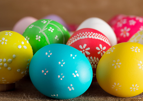 Colorful Easter eggs background. holiday, Easter background. Colorful Easter eggs on the green garden yard. symbol of Easter's day festival. vivid color natural background. festive wallpaper.