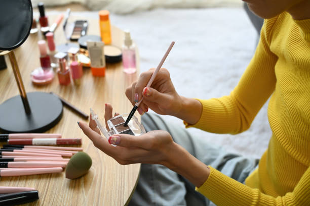 istock Smiling Asian gay man blogger filming daily makeup routine tutorial on smartphone. LGBTQ, domestic life and beauty concept. 1497104419