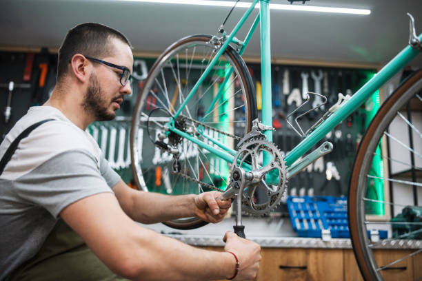 istock Man working in his own bike workshop and fixing bikes. 1497107549