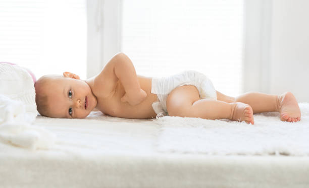 istock Happy baby lying on bed 1497107914