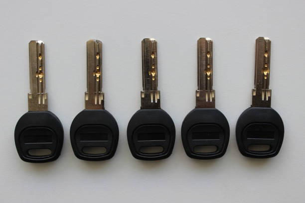 Metal Keys With Black Plastic Heads In A Row