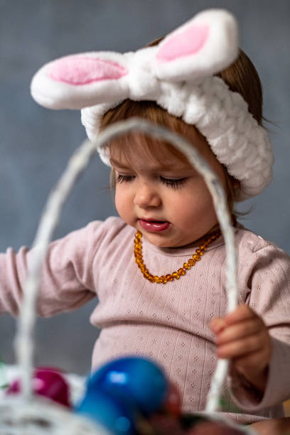 istock the baby plays with Easter eggs and wears bunny ears on his head 1497109357