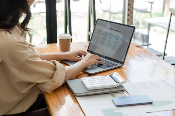istock Businesswoman accountant using a graphs and charts to analyze market data, balance sheets, accounts and net profits in order to plan new sales strategies and increase production capacity 1497116207