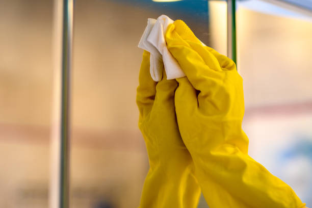 istock Cleaning services, cleaning a large mirror in the bathroom 1497116261