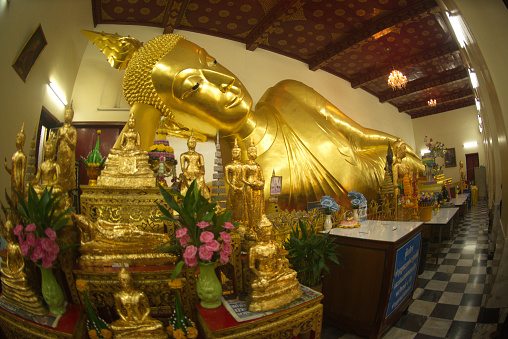 The large golden reclining Buddha on a Buddhism Church at Wat Pra Pathom Jedi temple is a largest Pagoda in the World at Nakhon Pathom Province , Middle of Thailand.