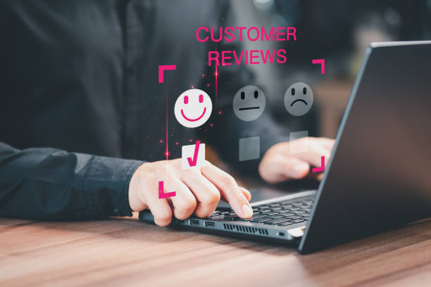 istock Customer service experience and business satisfaction survey. Man hand using a computer laptop with pop up smiley face icon for assessment feedback review satisfaction opinion and testimonial. 1497119132