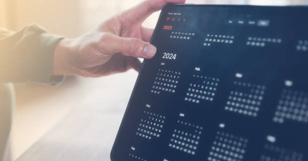 istock Concept of time management financial planning and reminder for 2024. man using computer tablet working with calendar 2024, business planning marketing and investment, schedule appointment meeting 1497120581