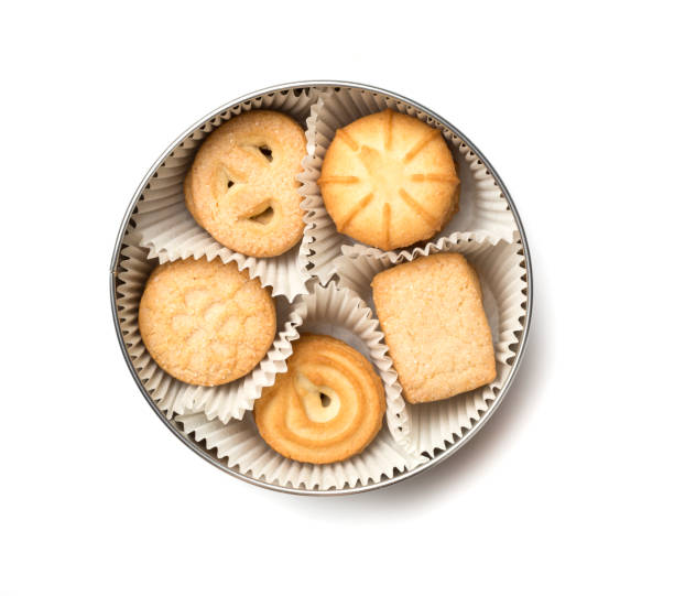 istock Tasty cookies in tin isolated on white background, top view 1497124957