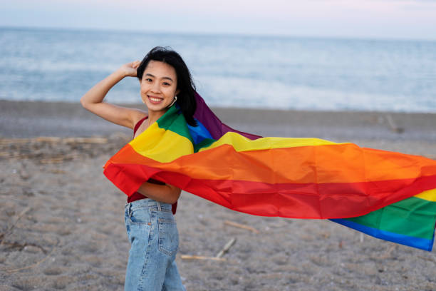 istock Happy girl with a pride flag at the beach. 1497125842
