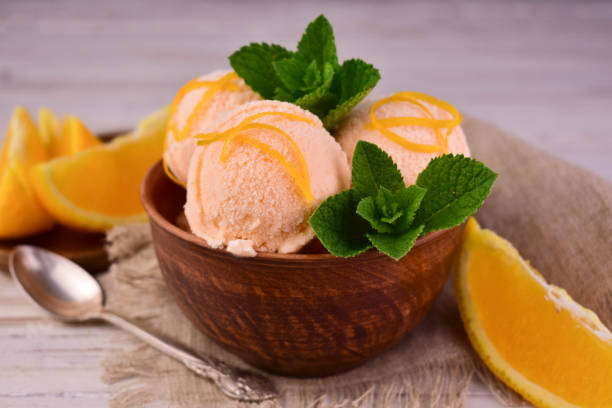 istock Orange ice cream with mint in a clay bowl.Close-up. 1497126305