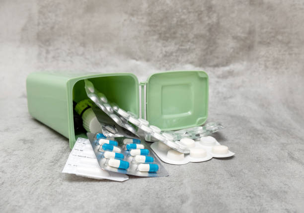 istock many pills capsules in trash bin or  woman hand 1497128199