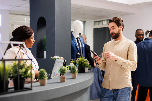 istock Male customer paying with smartphone 1497128323
