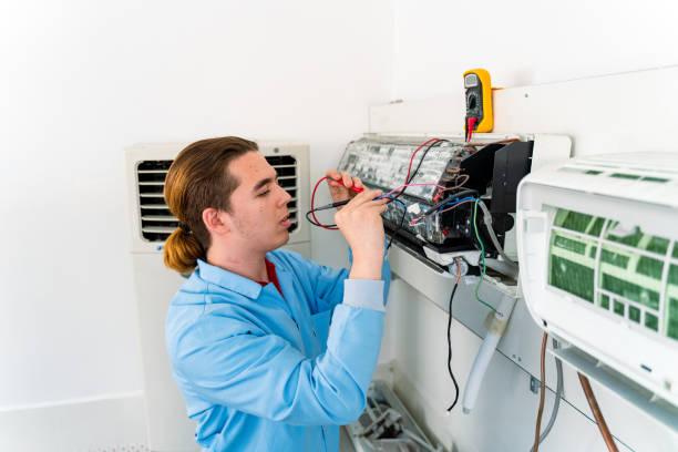 istock Air conditioner repairman works on home unit 1497129566