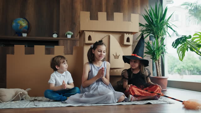 Princess, Prince And Witch Playing Role Play Game At Home With Castle Made Of Cardboard