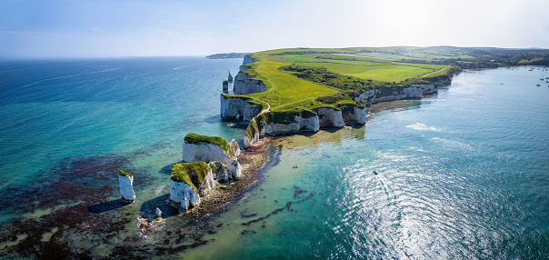 Panoramic aerial landscape view of the Old Harry Rocks headland, Dorset, England, during a sunny spring day