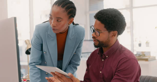 istock Black people, business and teamwork on computer, tablet and technology for planning, strategy and data analytics. Employees consulting digital website for collaboration, research or office project 1497133660
