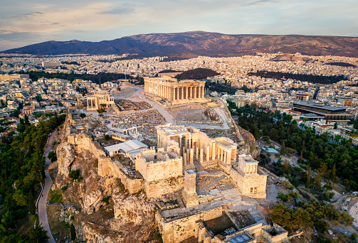 Beautiful aerial sunset view of the Parthenon Temple at the Acropolis of Athens, Greece, with soft sunlight relfected from the marble columns