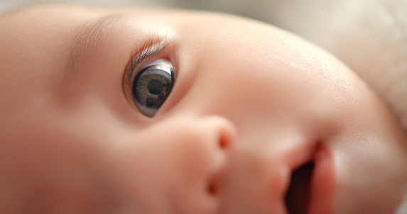 Baby, face and closeup of newborn, eye and vision with health, development and growth in early childhood. Eyesight, pupil and iris with curious infant, healthy kid and growing with child care