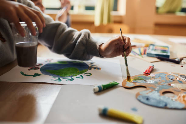 istock Close up of a student using watercolor paints on art class. 1497138044