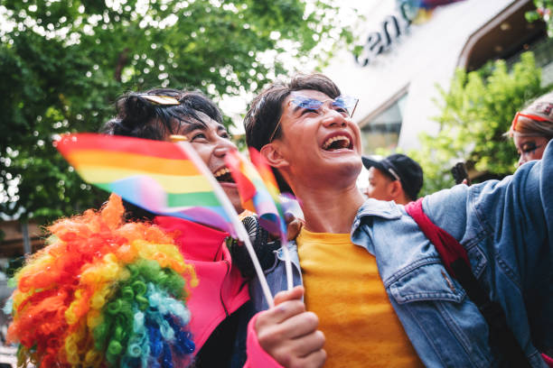 istock Young Asian gay couple during Pride parade 1497138123