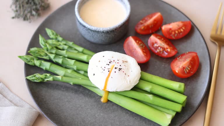 Asparagus baked with bacon and arugula and tomato salad. Healthy eating. Diet.