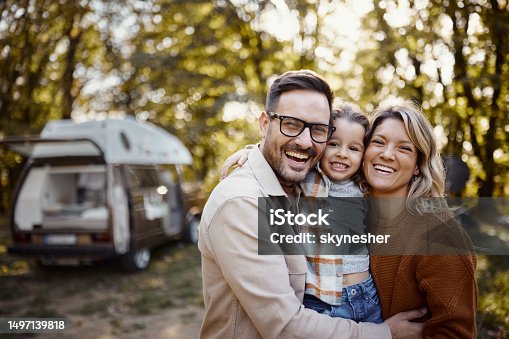 istock Portrait of happy family in autumn day at trailer park. 1497139818