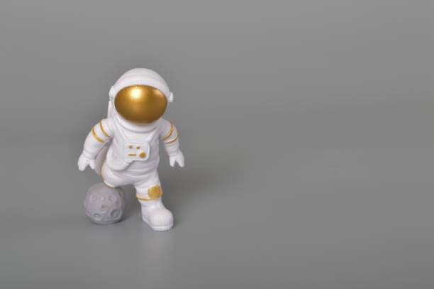 istock Astronaut toy in action isolated on a grey background. 1497139819