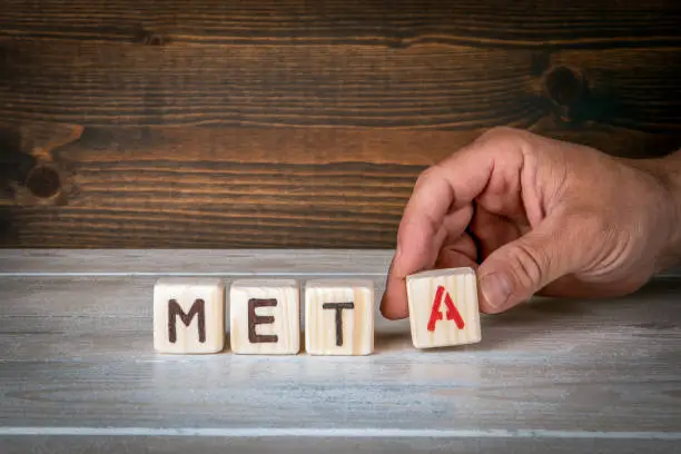 Photo of META. A word from wooden blocks