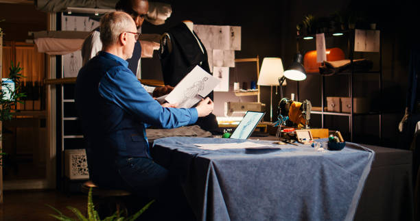 istock Old couturier teaching pupil skills 1497139943