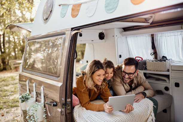 istock Happy family using touchpad inside of a camper trailer. 1497140897