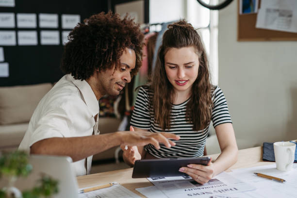 istock Young colleagues working together in startup company. 1497141105