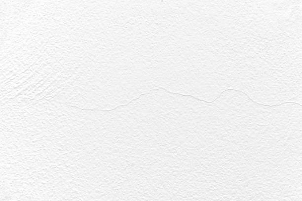 istock Cracked white painted wall. Peeling painted concrete wall. 1497143144