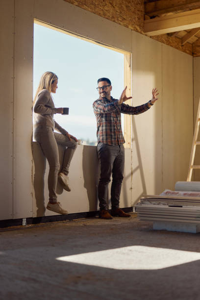 istock Happy couple talking about plans inside of their developing house. 1497143918