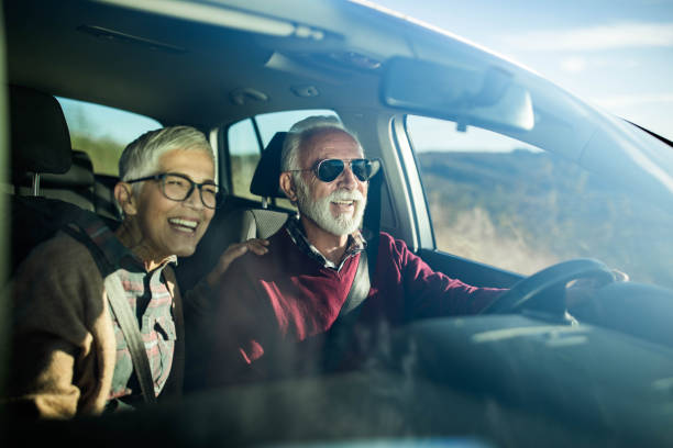 istock Happy senior couple going on a trip by car. 1497145181