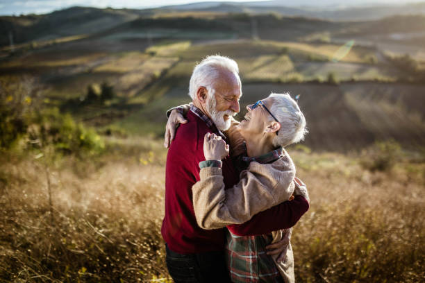 istock Affectionate senior couple talking to each other in autumn day. 1497145248