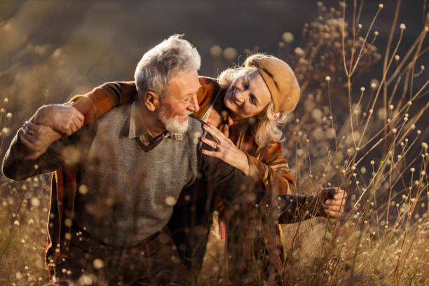 istock Cheerful mature couple having fun in autumn day. 1497145277