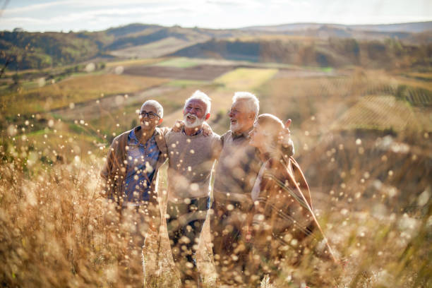istock Happy senior couples having fun while walking embraced up the hill. 1497145361