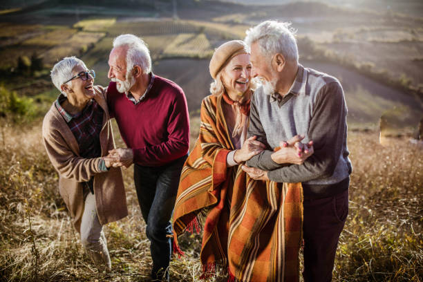 istock Happy mature couples talking while walking on the hill in autumn day. 1497145969